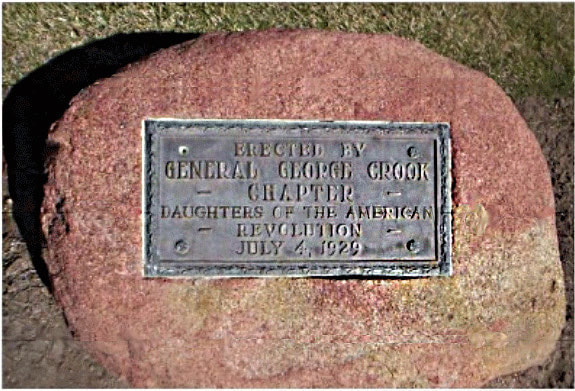 A snapshot of a redstone marker with a bronze plaque that reads, “Erected by General George Crook Chapter / Daughters of the American Revolution, July 4, 1929.”