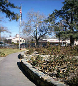 A snapshot of the grounds of the house of the first Arizona Territory governor with the flagpole and marker in the background.