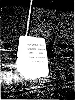 A vintage snapshot of a marker without details; text is unreadable.