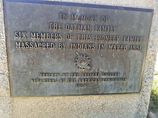 A snapshot of a plaque that reads, “In memory of the Oatman family / Six members of this pioneer family massacred by Indians in March 1851 / Erected by the Arizona Society Daughters of the American Revolution 1954.”