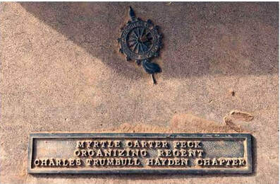 A snapshot of the DAR marker with insignia, that reads, “Myrtle Carter Peck Organizing Regent / Charles Trumbull Hayden Chapter.”