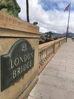 A snapshot of the sidewalk near the bridge with a plaque reading “London Bridge.”