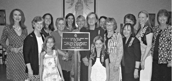 A snapshot of a group of women and girls with the marker. Text is not distinguishable.