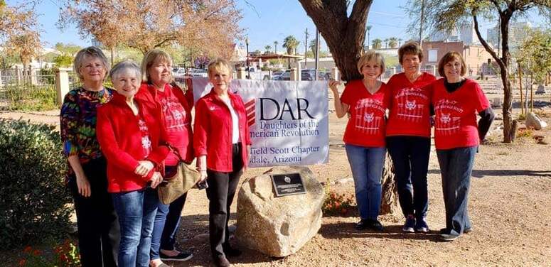 A group of seven women gathered at the original marker. Marker text is in the body of this page.