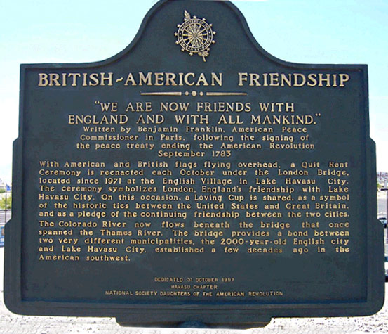 A snapshot of a marker that reads, “British-American Friendship / “We are now friends with England and with all mankind.” / Written by Benjamin Franklin, American Peace Commissioner in Paris, following the signing of the peace treaty ending the American Revolution September 1783 / With American and British flags flying overhead, a Quit Rent Ceremony is reenacted each October under the London Bridge, located since 1971 at the English Village in lake Havasu City. The ceremony symbolizes London, England’s friendship with Lake Havasu City. On this occasion, a Loving Cup is shared, as a symbol of the historic ties between the United States and Great Britain, and as a pledge of the continuing friendship between the two cities. The Colorado River now flows beneath the bridge that once spanned the Thames River. The bridge provides a bond between two very different municipalities, the 1000-year-old English city and Lake Havasu City, established a few decades ago in the American southwest.”